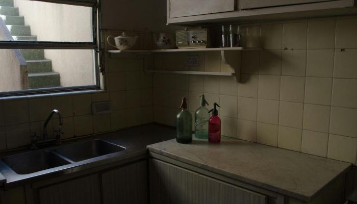 small outdated kitchen before renovation in Brandon FL with old countertops and cabinets
